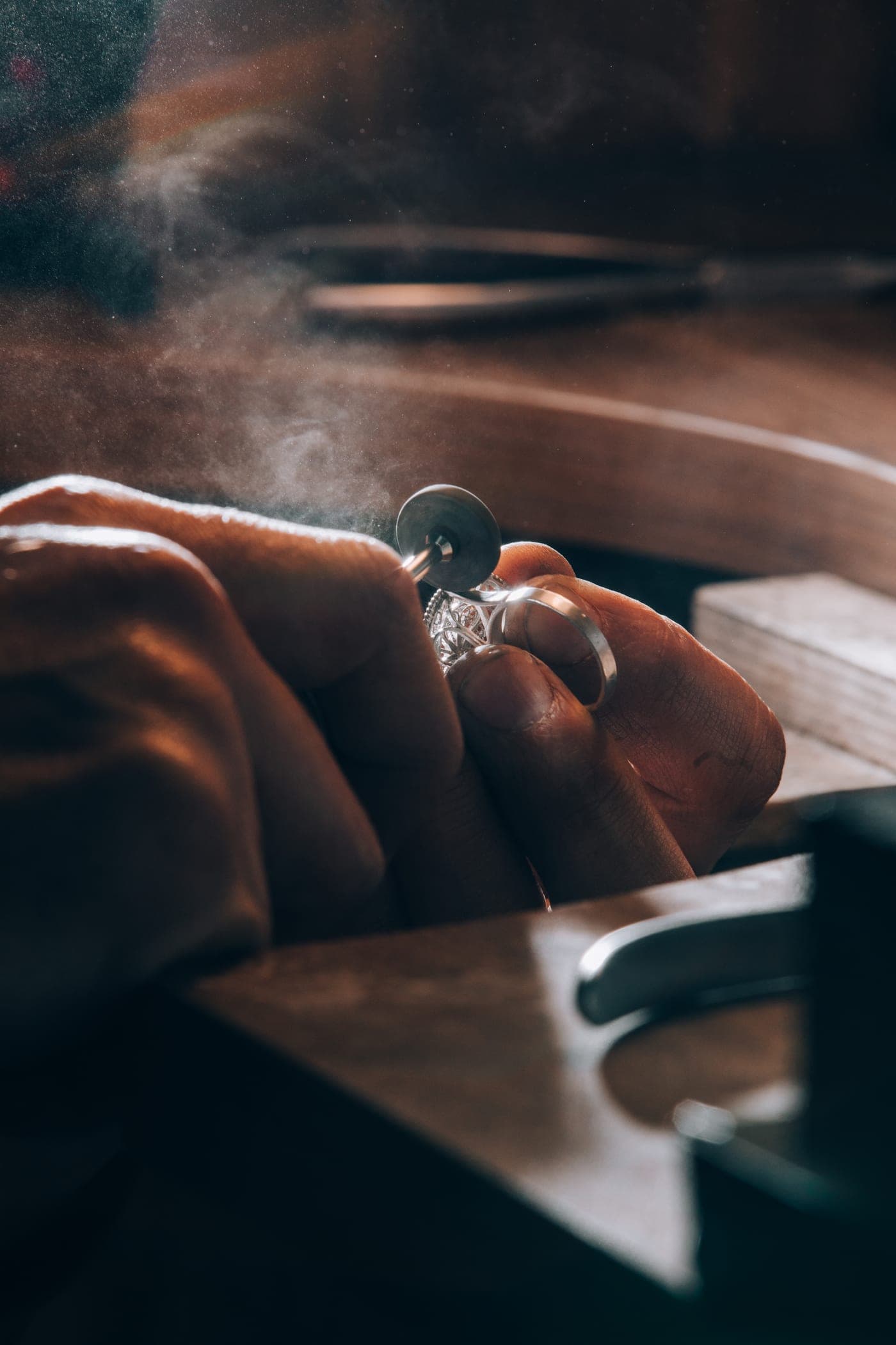 A goldsmith setting a ring at the workbench